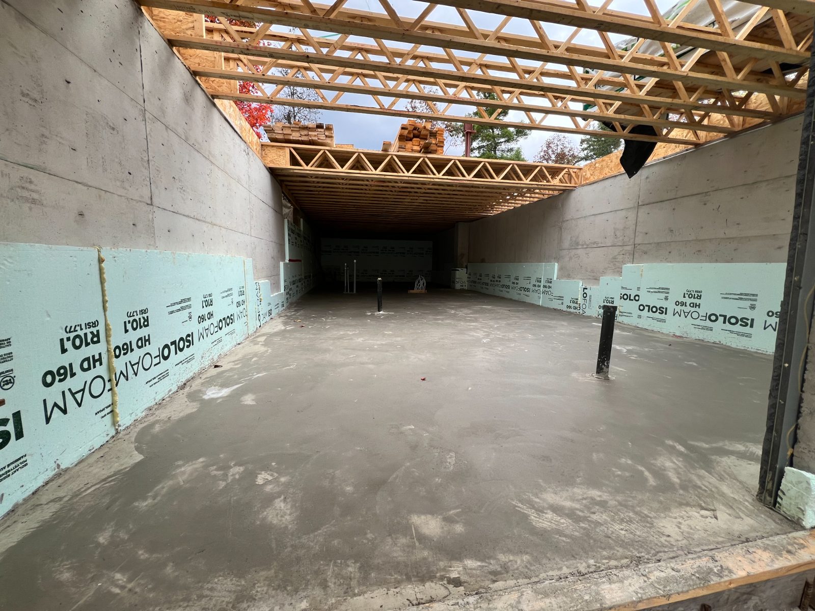 Freshly poured concrete floor between insulated foundation walls
