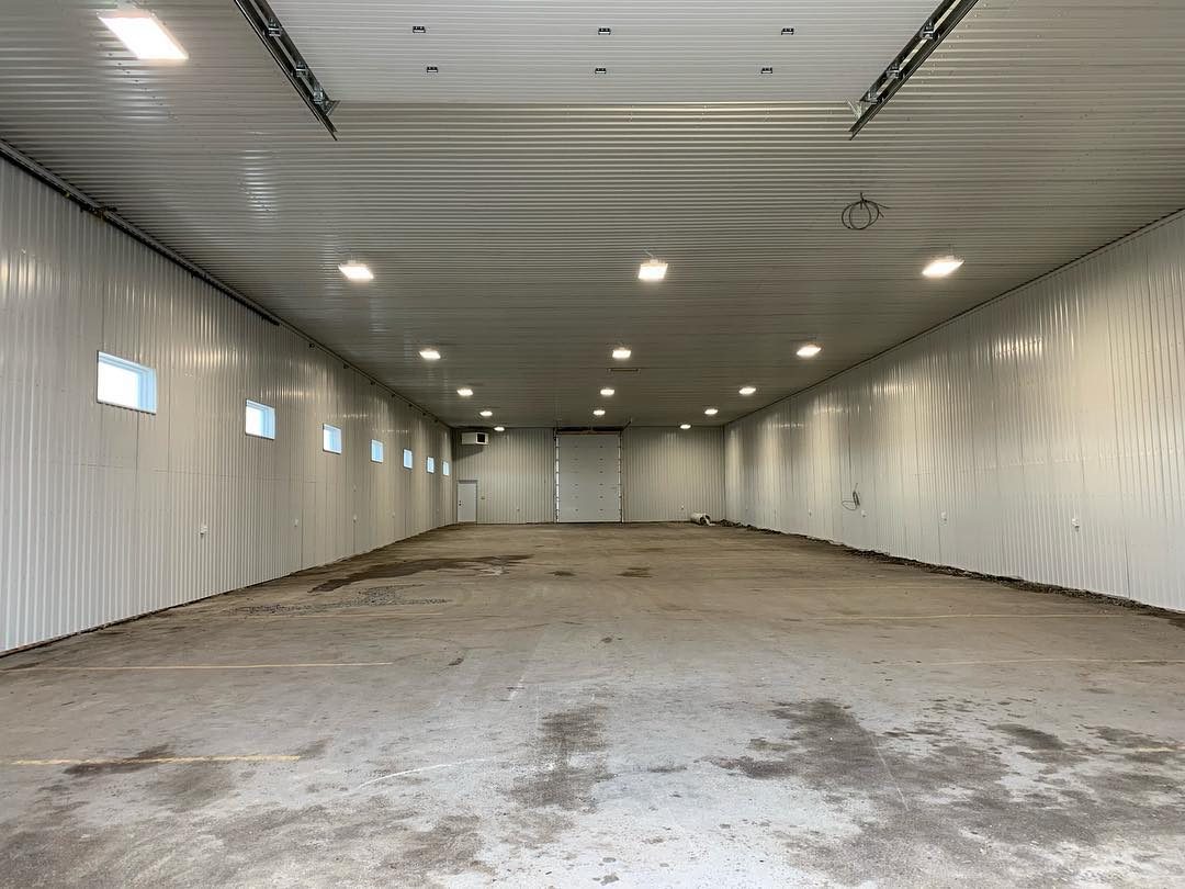 Warehouse hall converted to a bright finished space with new lighting