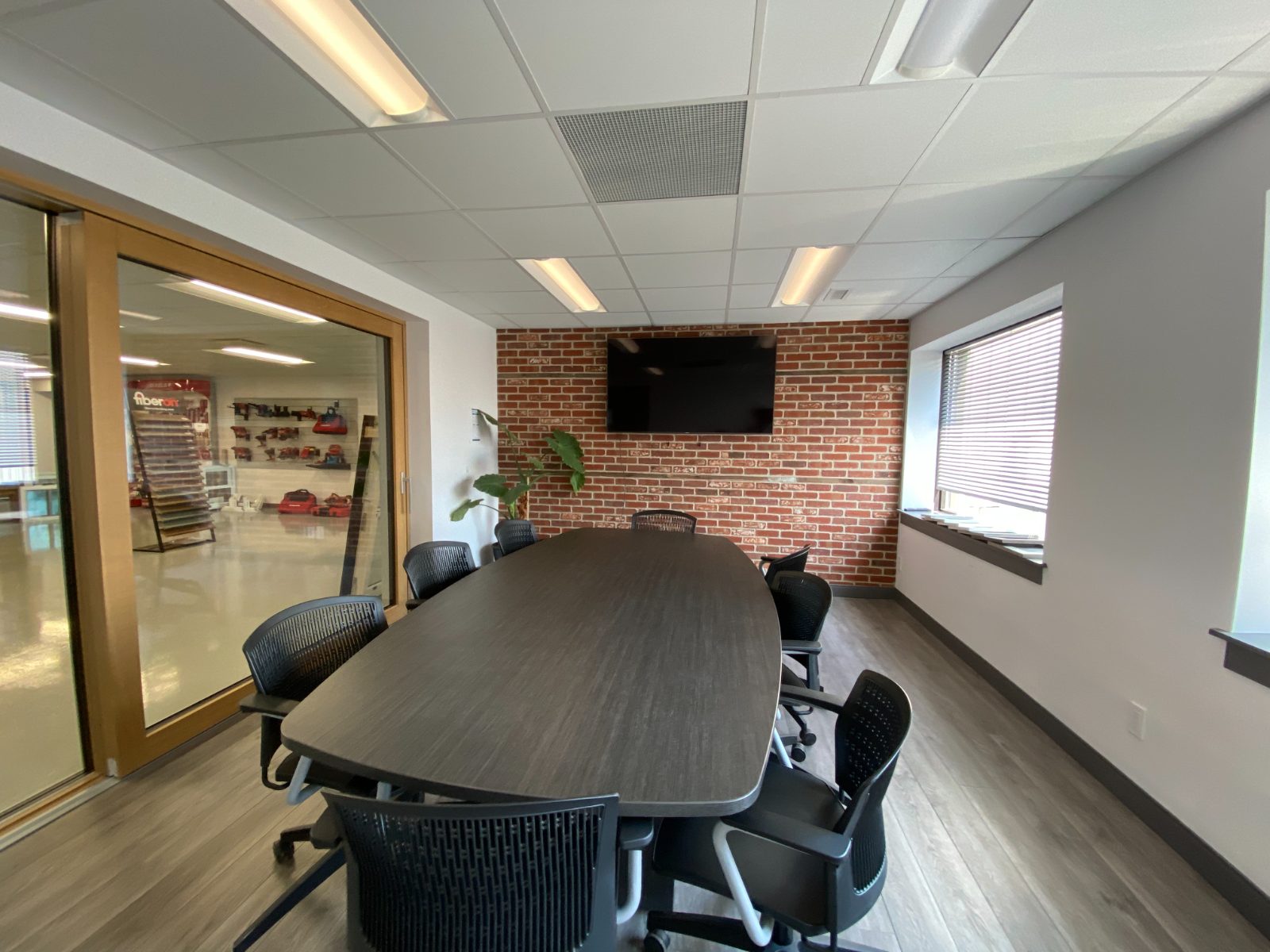 Boardroom with brick feature wall and mounted display