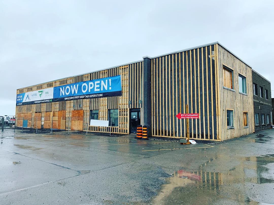 Retail building re-clad in charred-wood slats, opening day