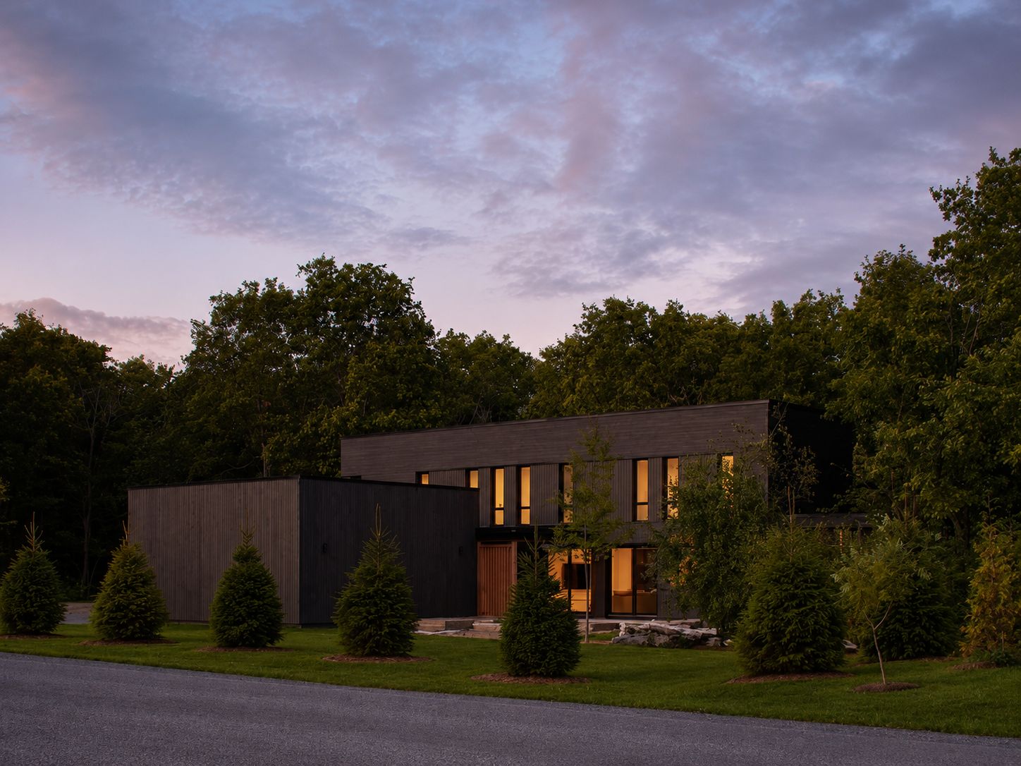 Charred-cedar high-performance home at dusk
