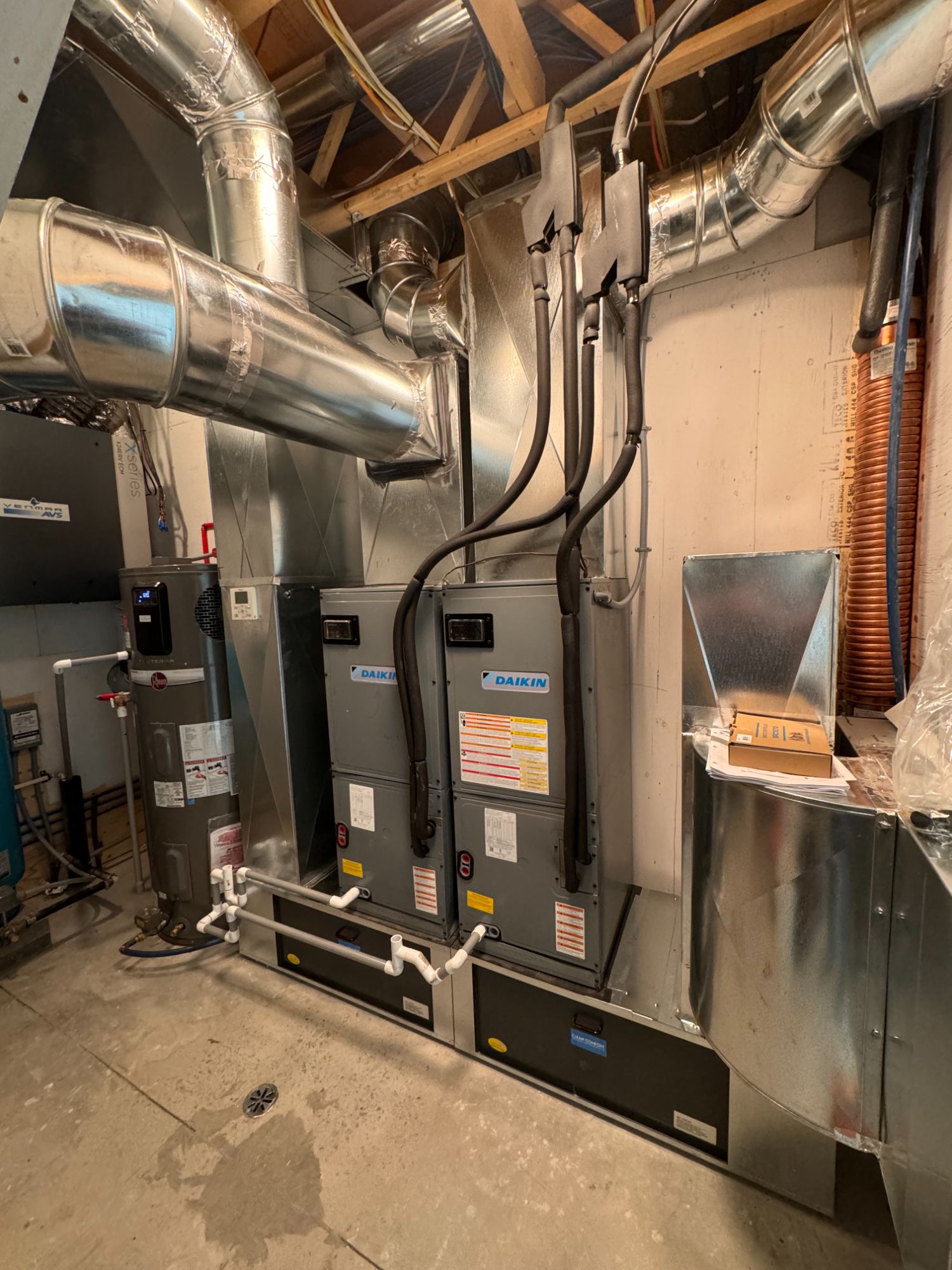 Mechanical room with twin Daikin heat pumps and heat-recovery ventilator