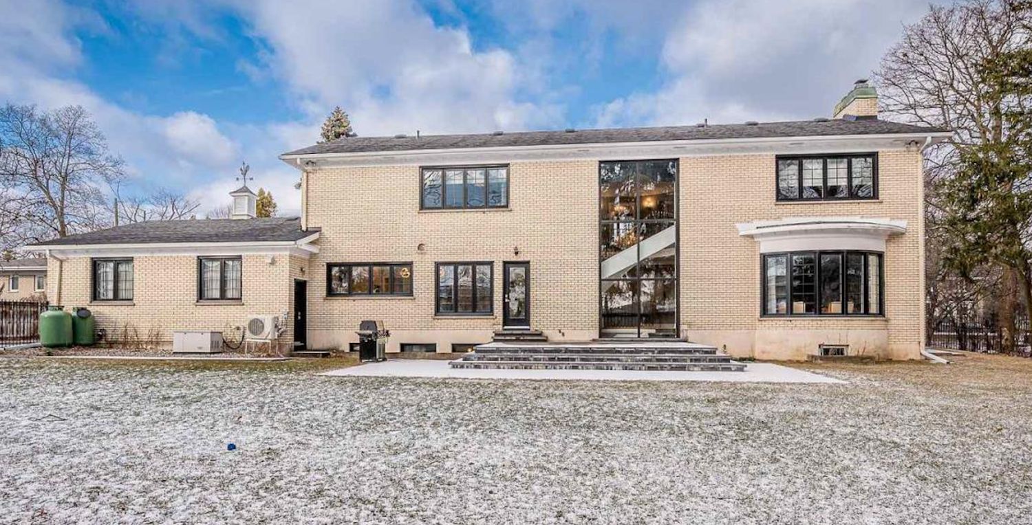 Rear of the estate with a two-storey glazed stairwell and new black-frame windows