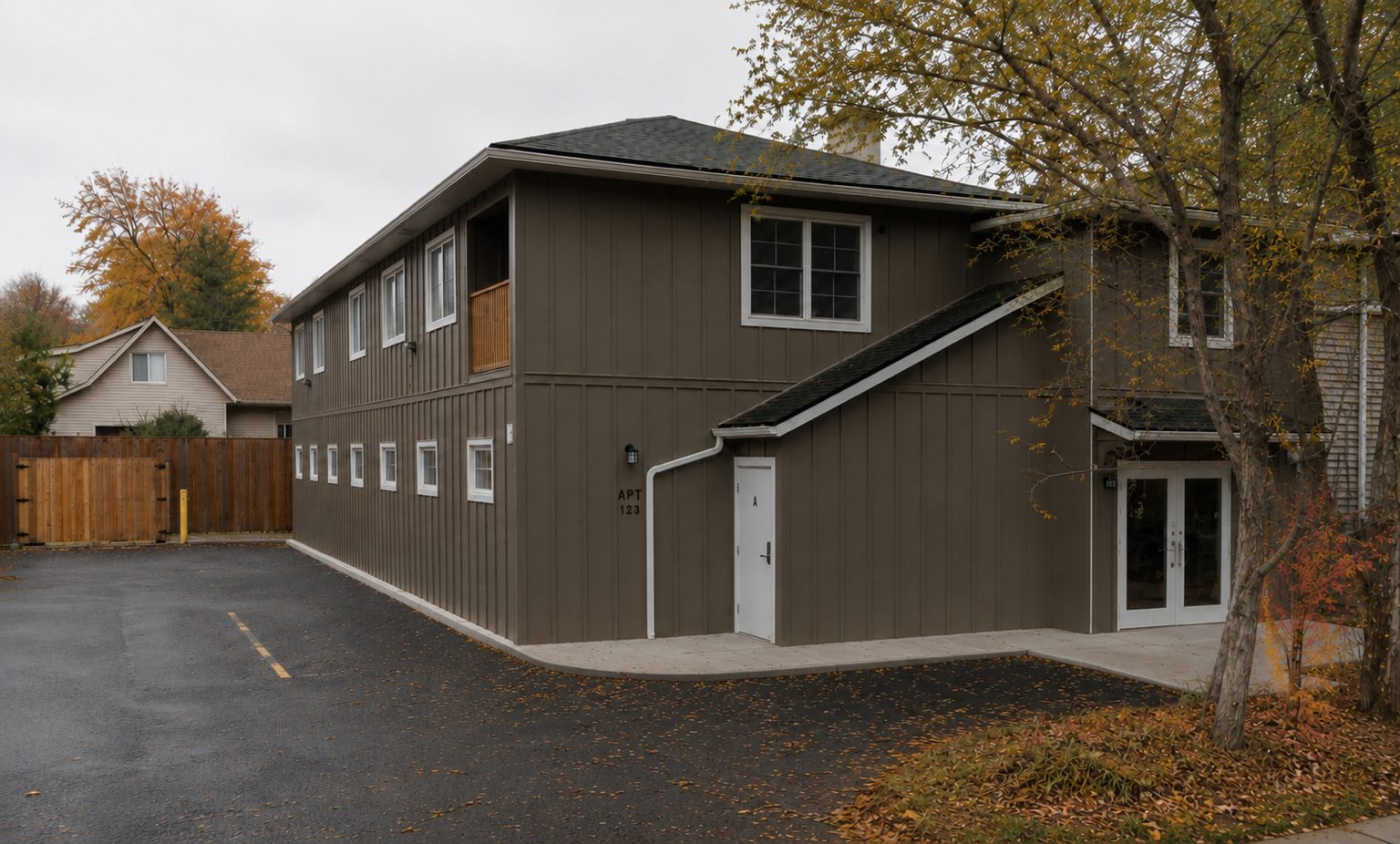 Completed board-and-batten clinic addition behind the limestone heritage house