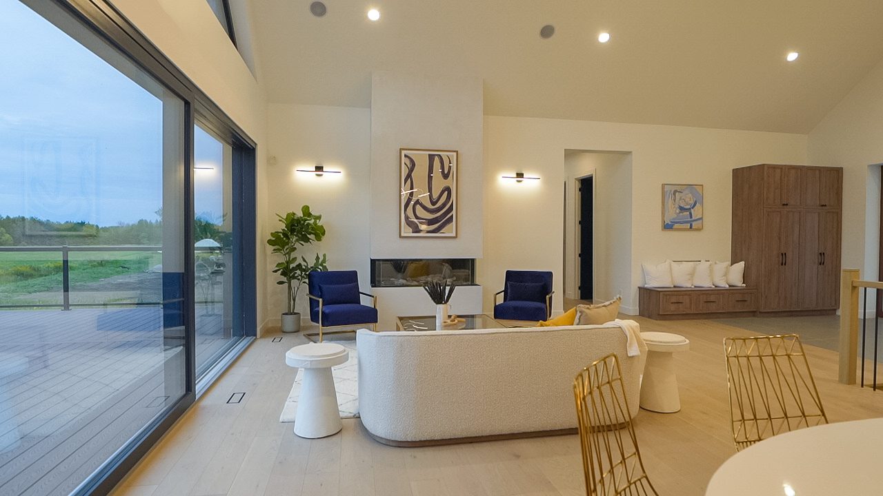 Vaulted living room opening to a walkout