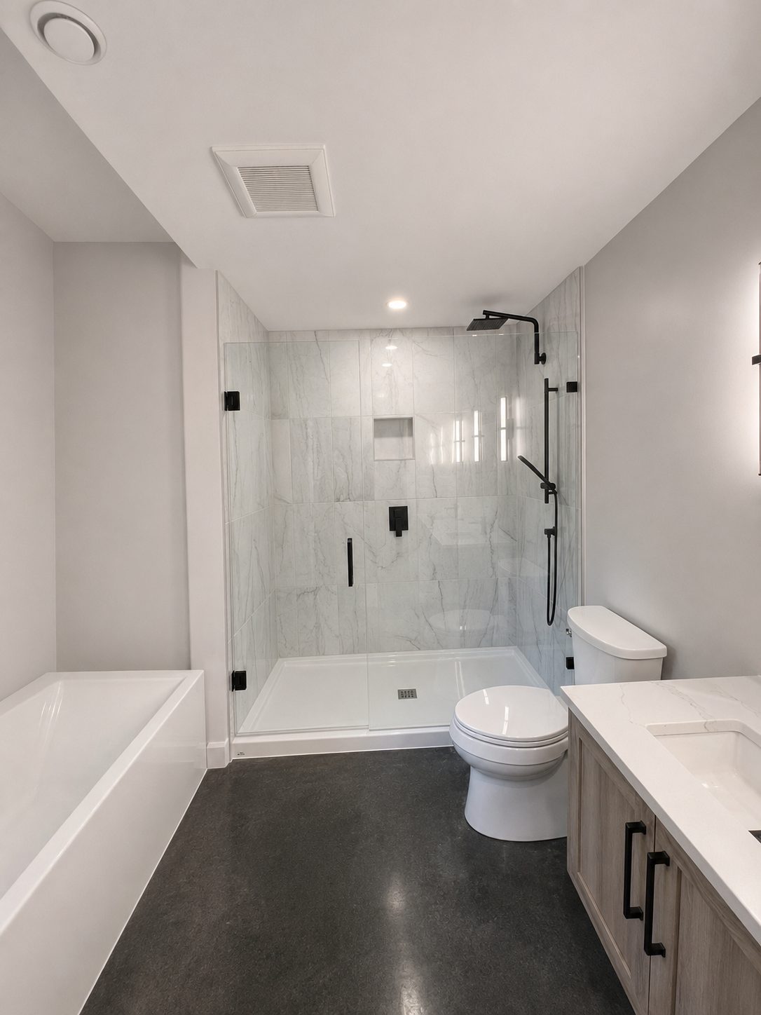 Primary bathroom with marble shower and black fixtures