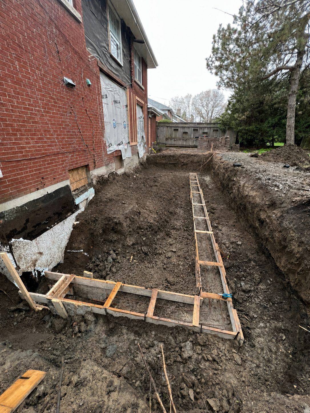 Excavation with footing forms tight to the existing foundation