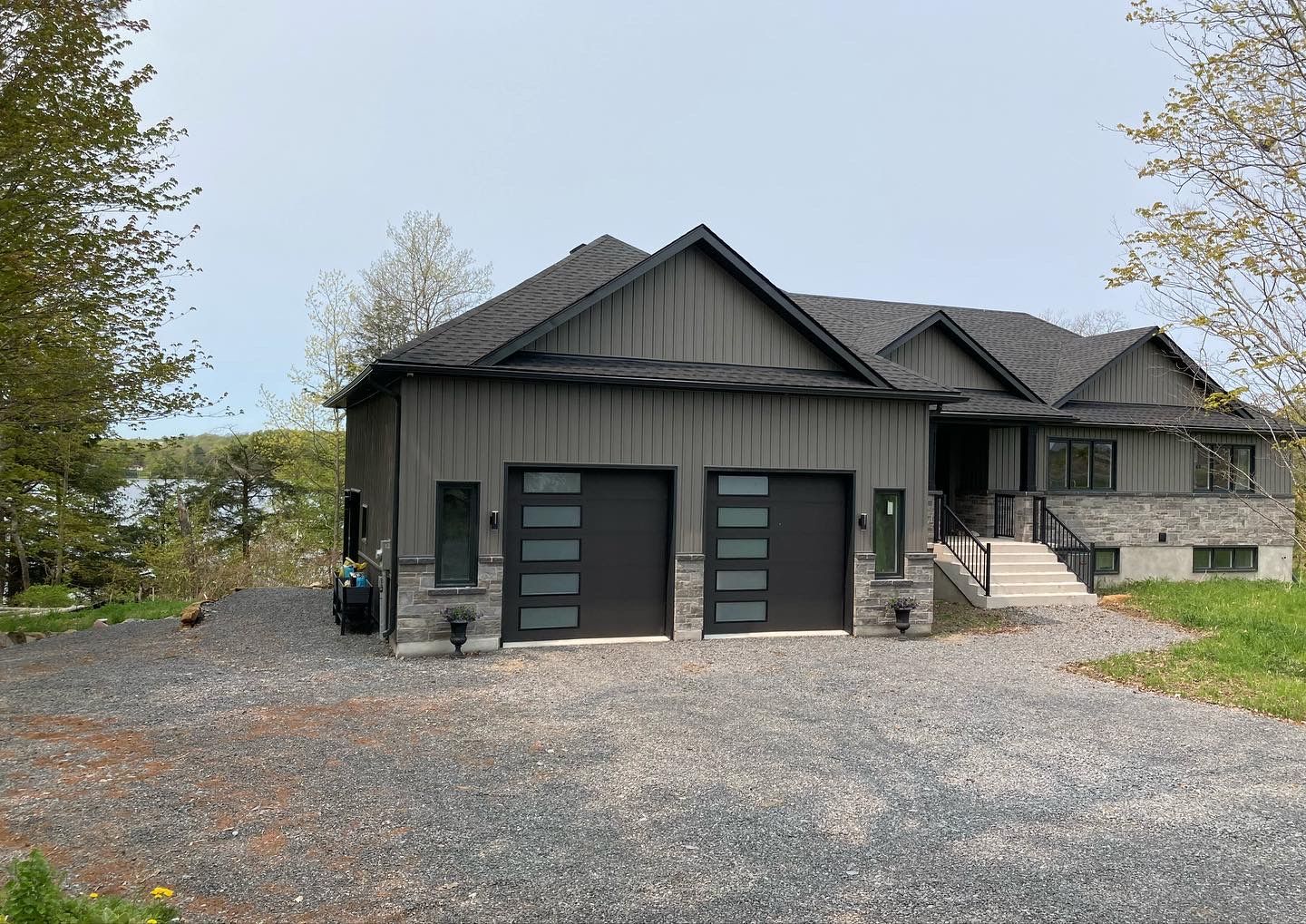 Finished front elevation with twin garages and stone base