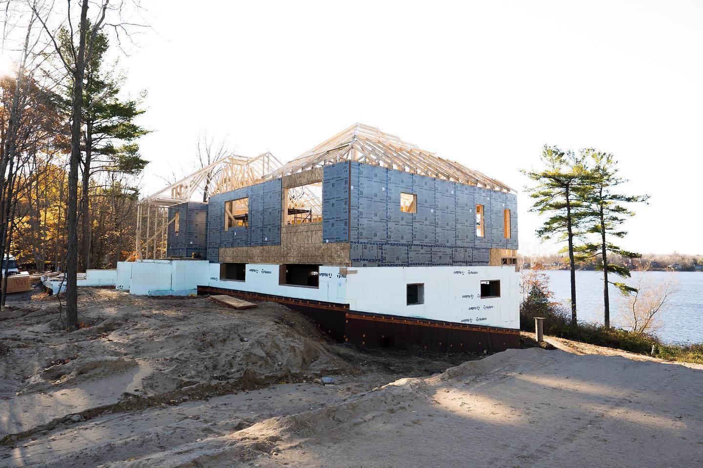 Framing rising on the ICF foundation beside the lake