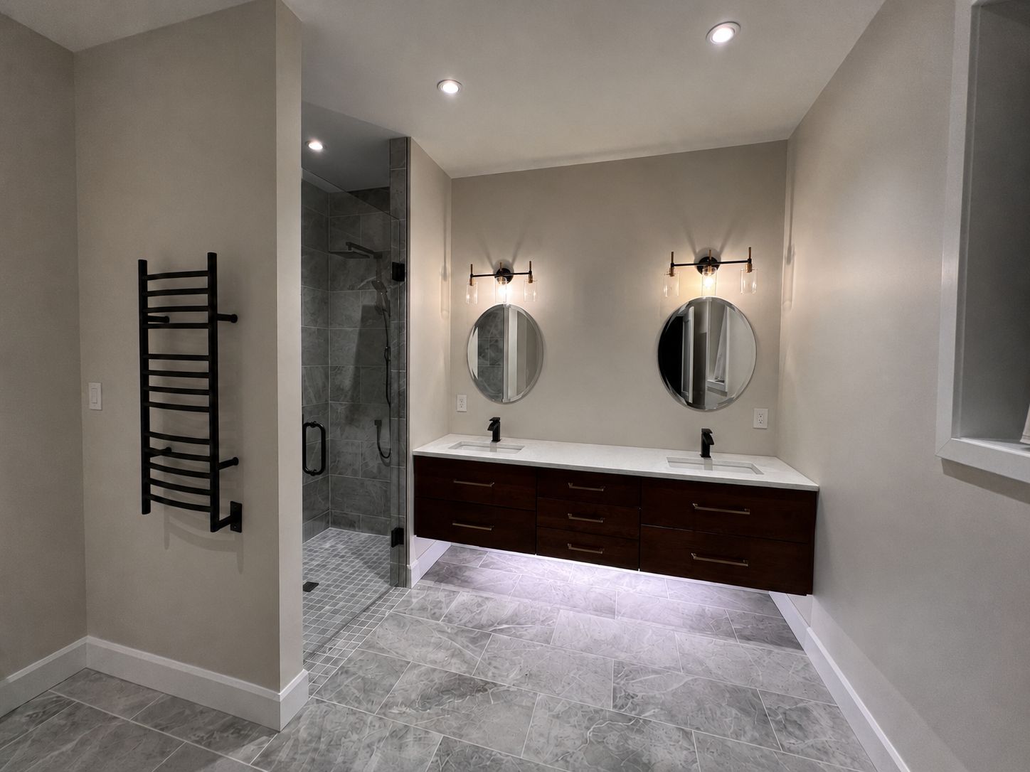 Finished bath with glass shower, floating double vanity and heated towel rail