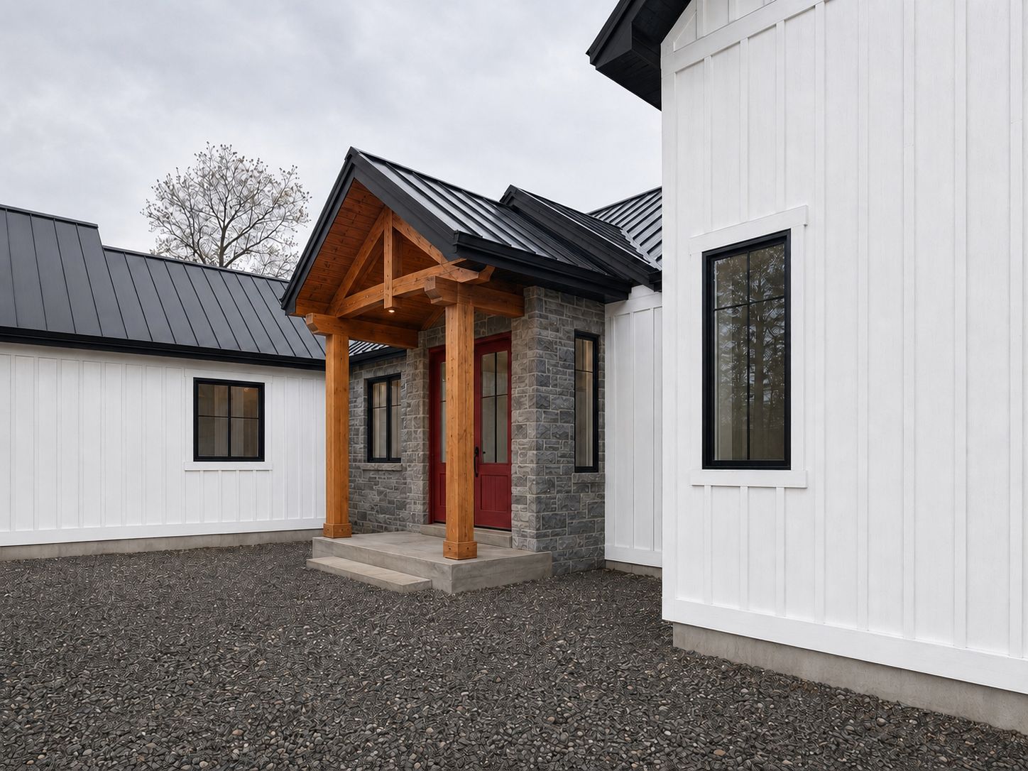 Exposed timber-frame entry with stone base and red door