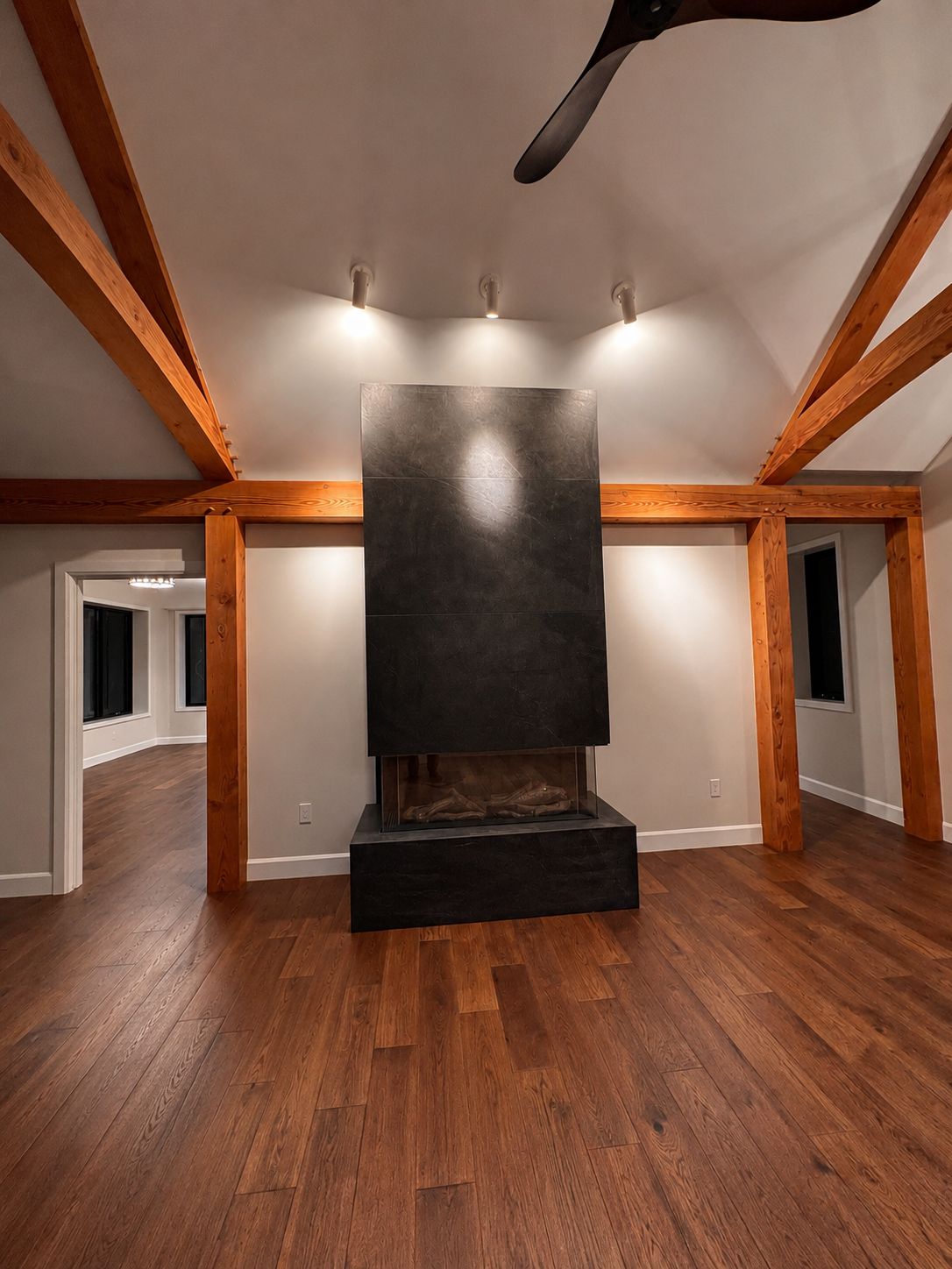 Great room with exposed timber beams and stone feature wall
